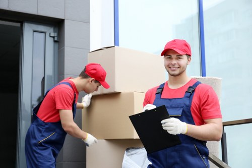 Professional furniture removals in Merton loading household items into a moving van