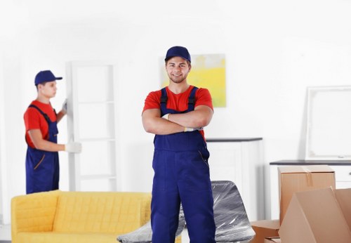 Loading furniture into a moving van in Merton