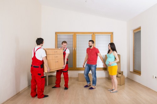 Loading furniture and boxes into a removals van in Merton