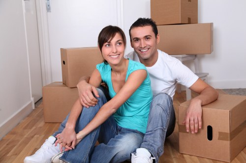 Professional movers packing household items for a home relocation in Merton