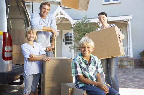 House moving team protecting furniture during transport in Merton