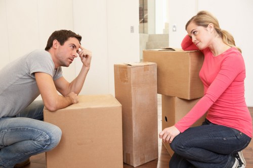 Local Merton movers transporting heavy furniture through a residential property