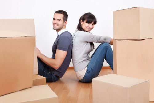 Furniture being carried carefully through a narrow stairwell during a flat move